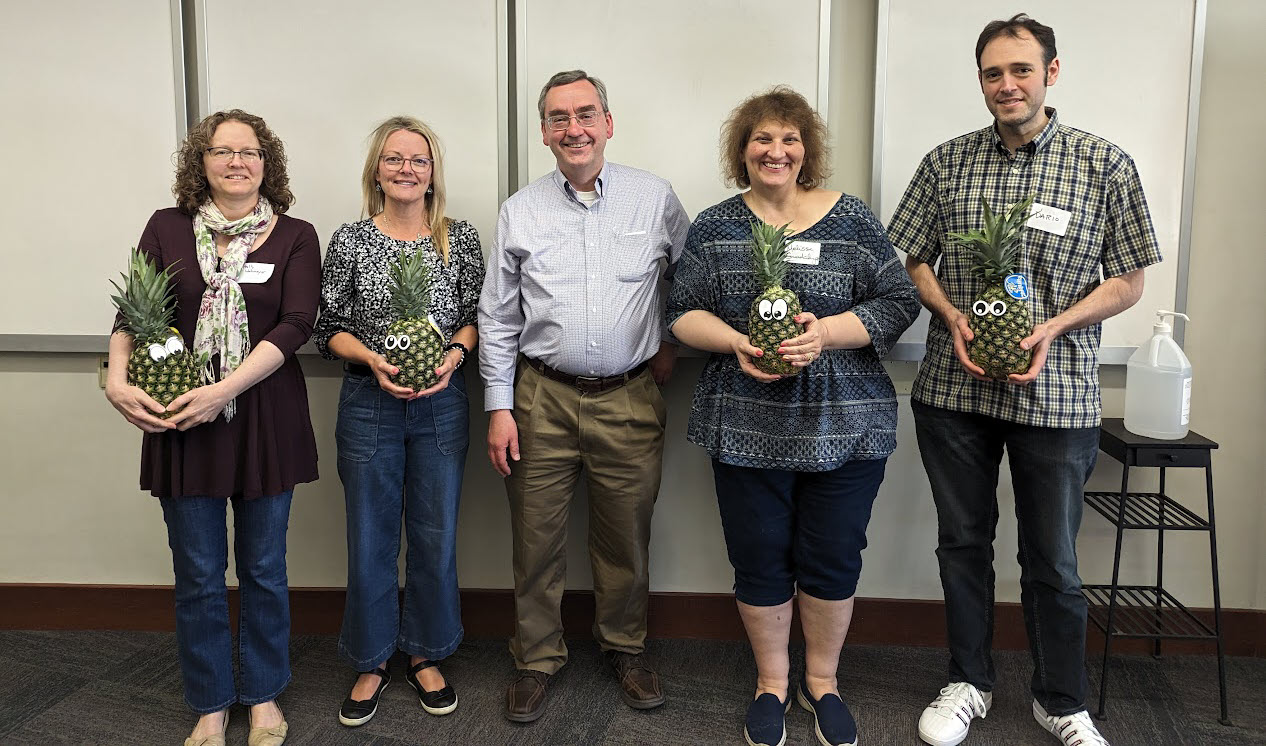 Faculty members Holly Wehmeyer, Michelle Cox, Melissa Layman-Guadalupe, and Dario Rodriguez pose with David Wright and pineapples to signify their graduation from ATLS. Dodd also holds a certificate.