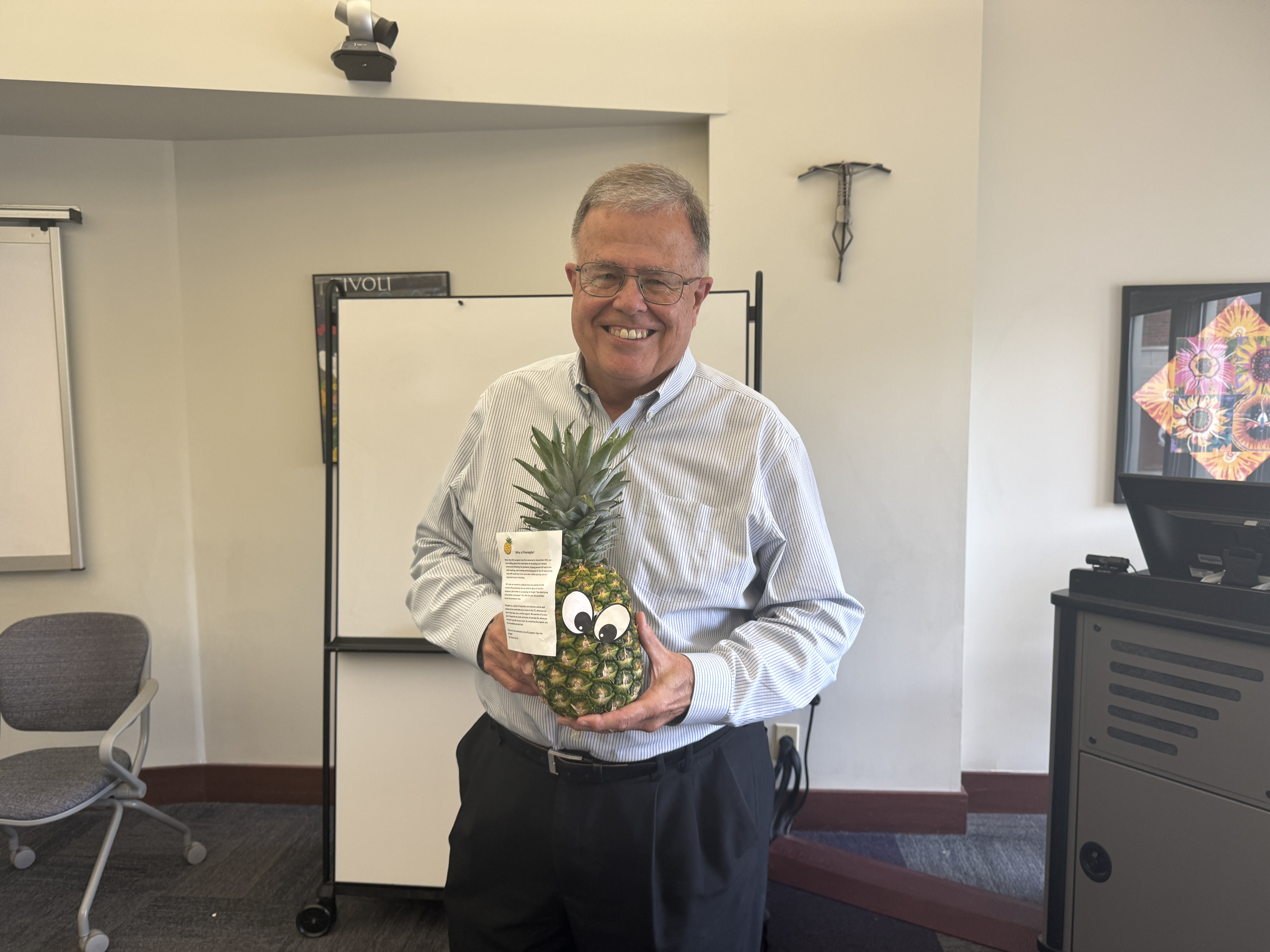 Faculty member Alan Kelley poses with a pineapple to signify his graduation from ATLS.