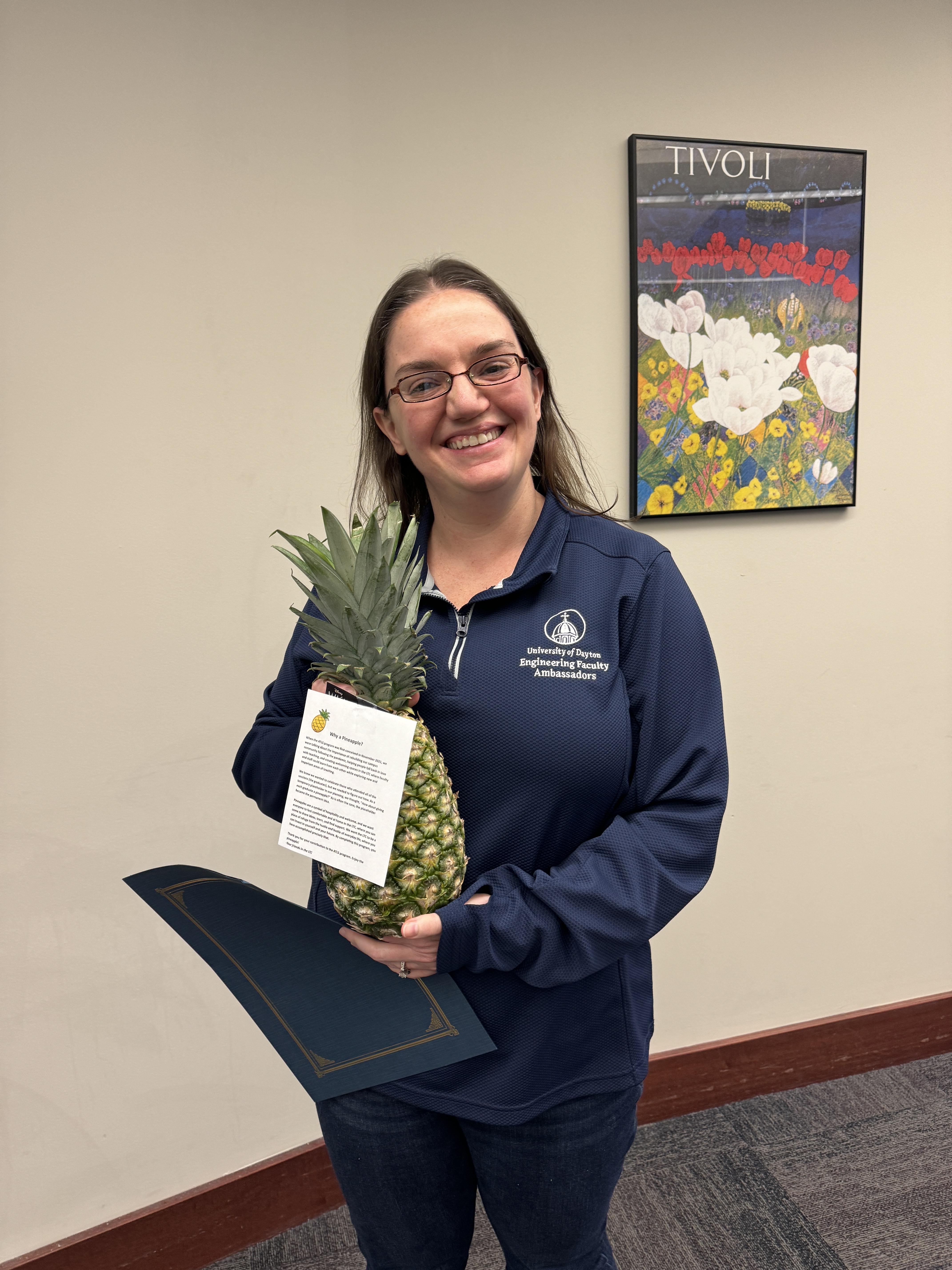 Faculty member Allison Kinney poses with a pineapple to signify graduation from ATLS.