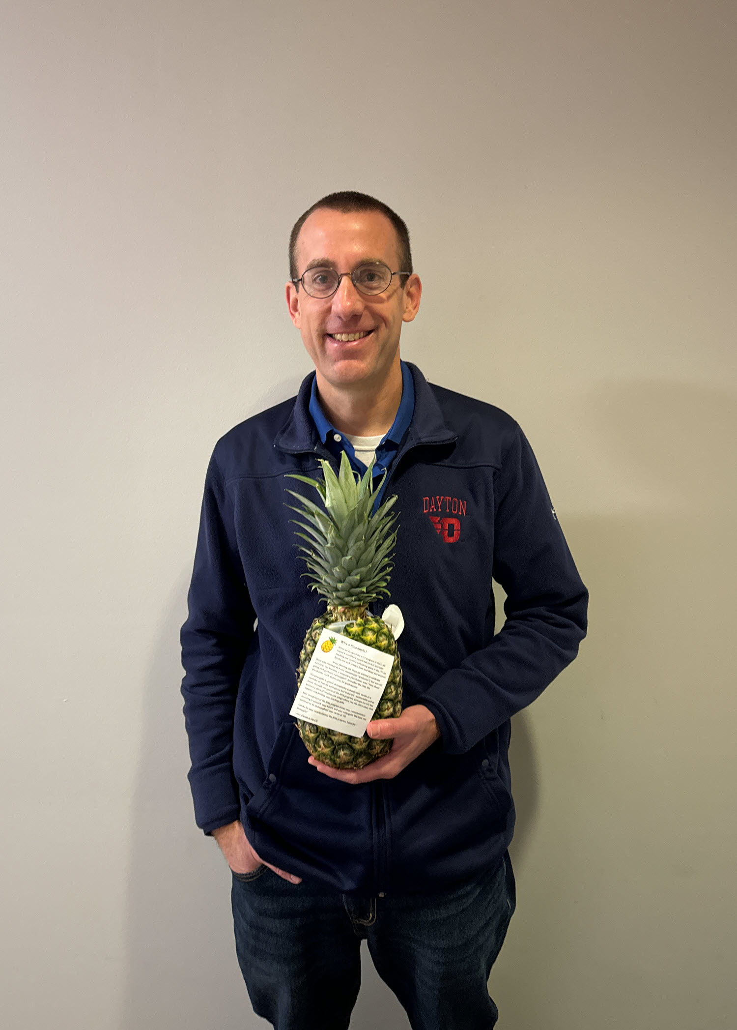 Faculty member Brian Rigling pose with a pineapple to signify graduation from ATLS.