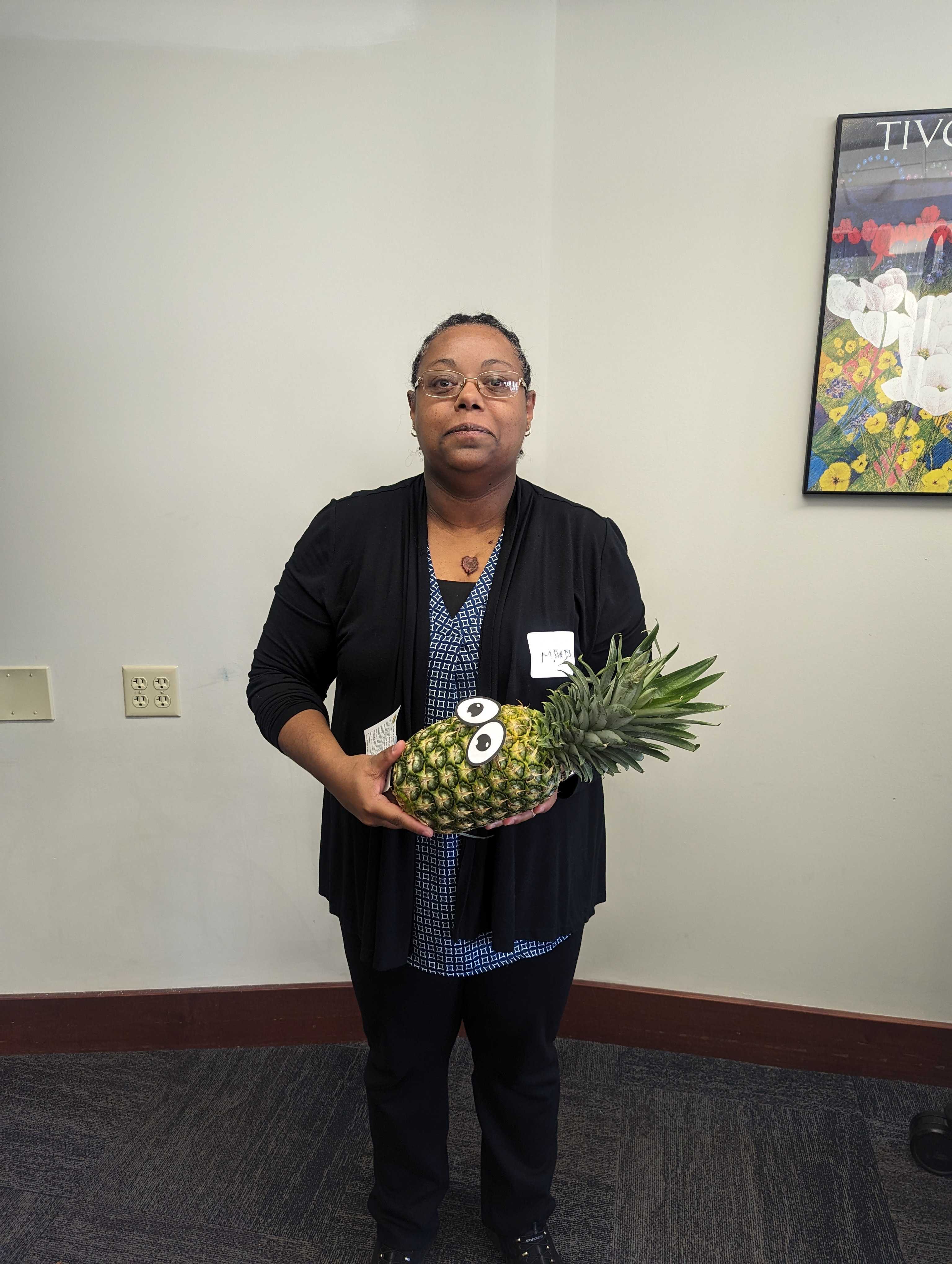 Faculty member Marda Messay poses with a pineapple to signify graduation from ATLS.